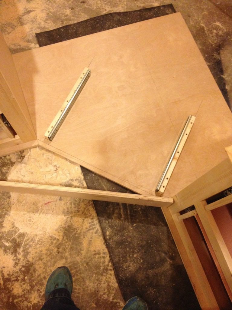 Middle corner desk drawer support blocks installed into bottom of desk top