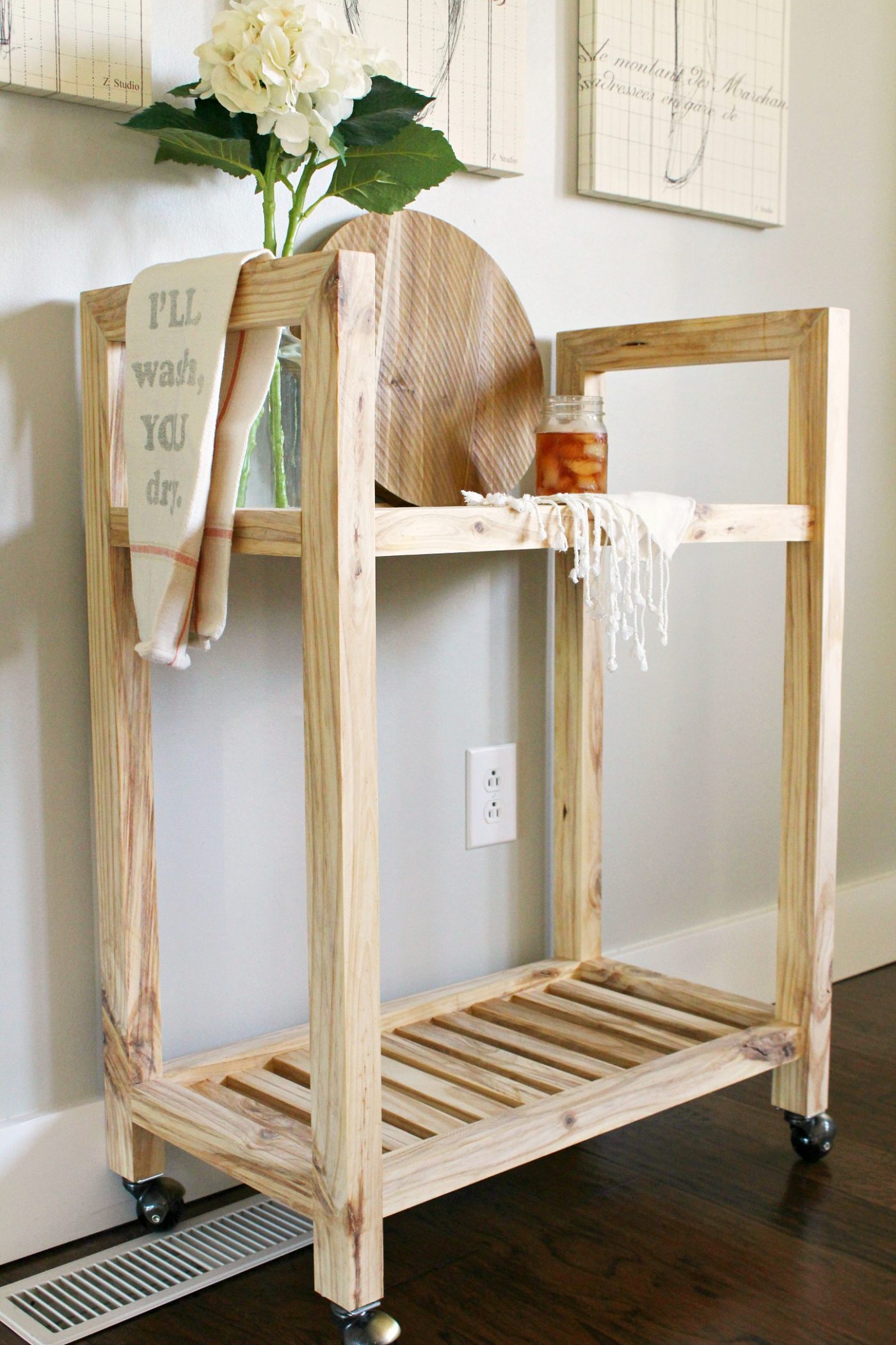 Simple Modern Bar Cart with natural wood finish on caster wheels