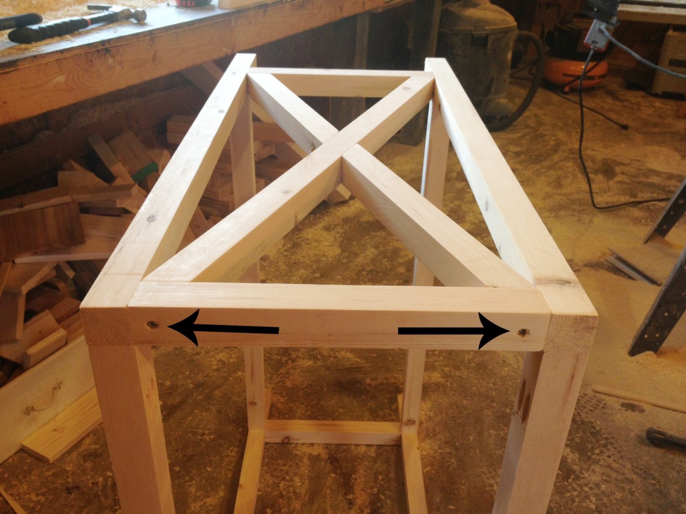 X base console table turned on side showing screws where X trim was secured on the side