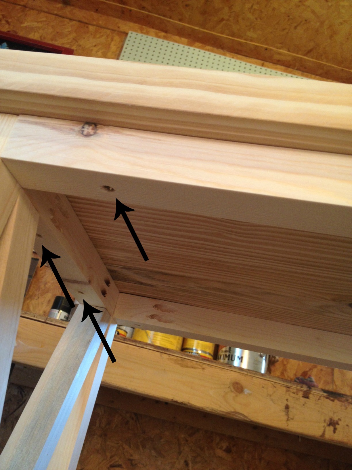 Screws from bottom side shown going through 2x2s to attach top panel
