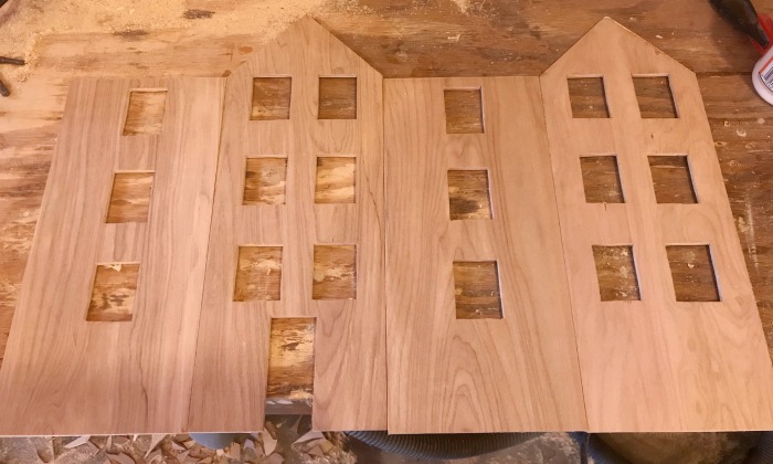 all four sides of house with windows and door cut out 