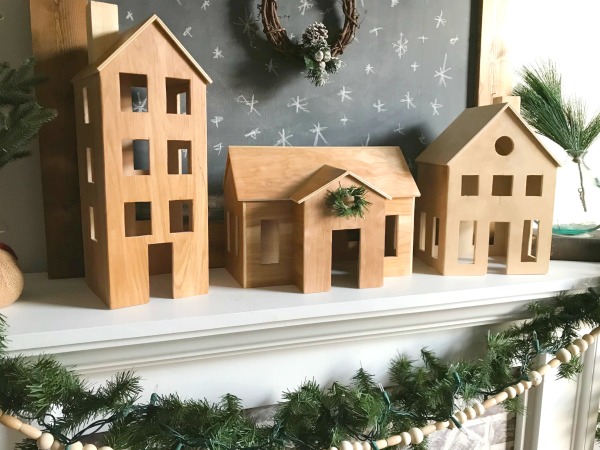 Scandi Style DIY Wooden Christmas village sitting on mantle