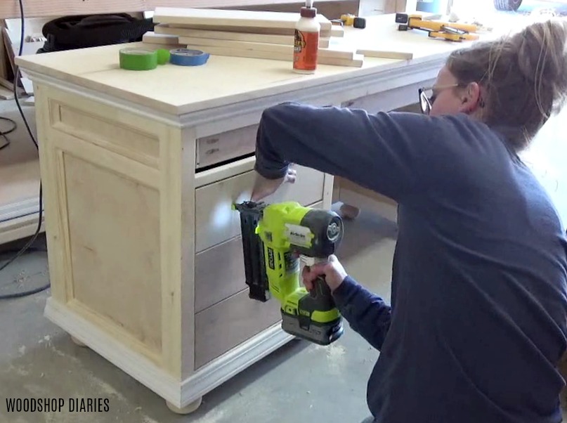 Shara Woodshop Diaries nailing drawer fronts onto drawer boxes of desk