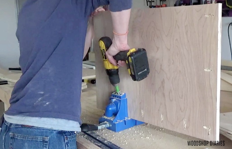Shara Woodshop Diaries drilling pocket holes in side panels of storage desk cabinets