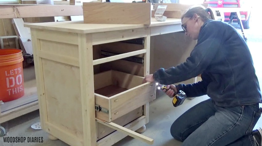 Shara Woodshop Diaries installing drawer boxes onto slides in DIY storage desk