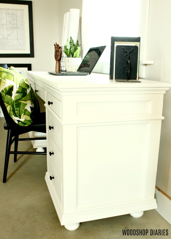 White home office desk with trim detail and black knobs