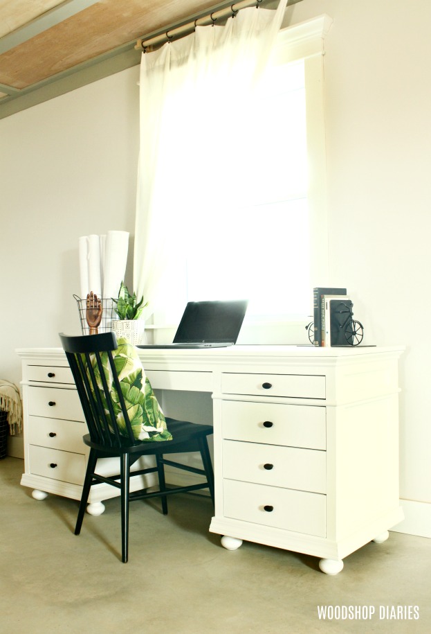 Completed DIY storage desk painted white with black knobs