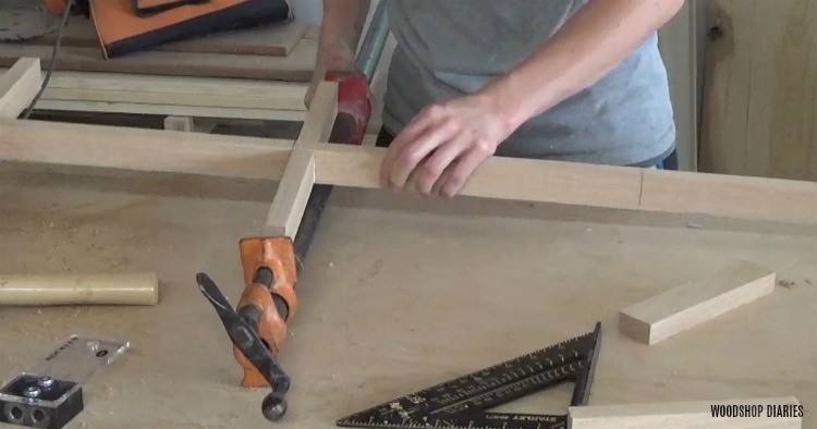 Shara Woodshop Diaries clamping 1x2s together to assemble glass door divider panel