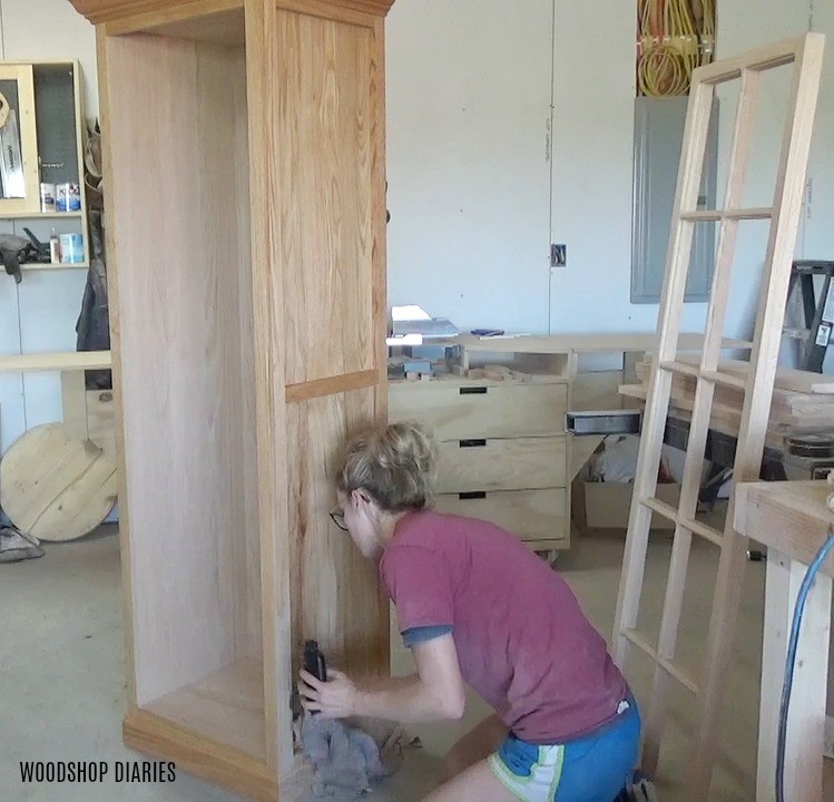 Shara Woodshop Diaries applying clear oil finish to red oak linen cabinet