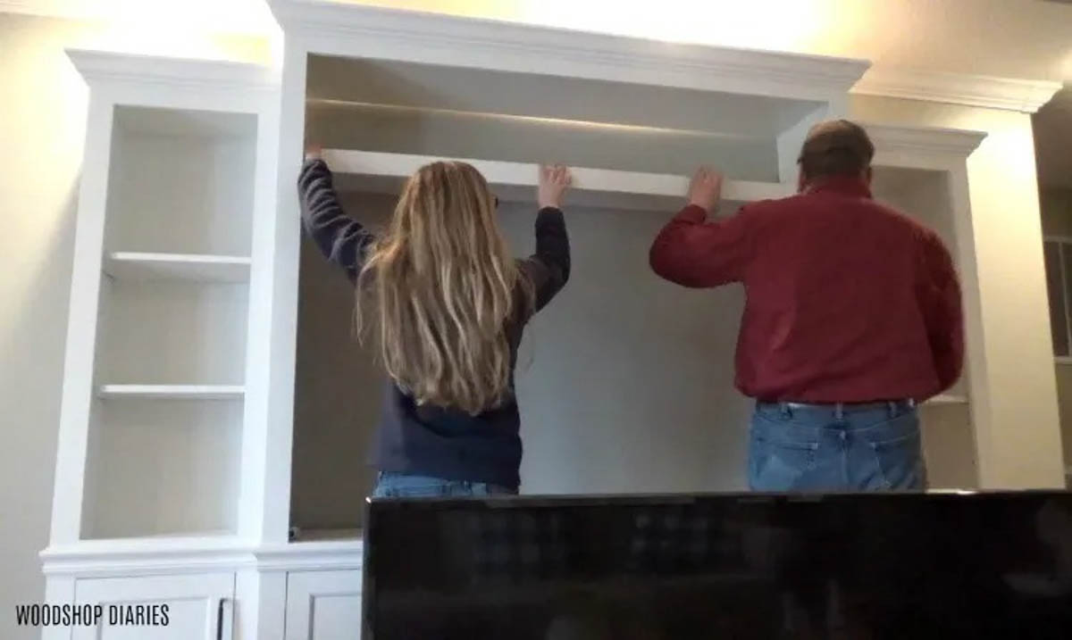Shara Woodshop Diaries installing shelves into completed DIY Entertainment center