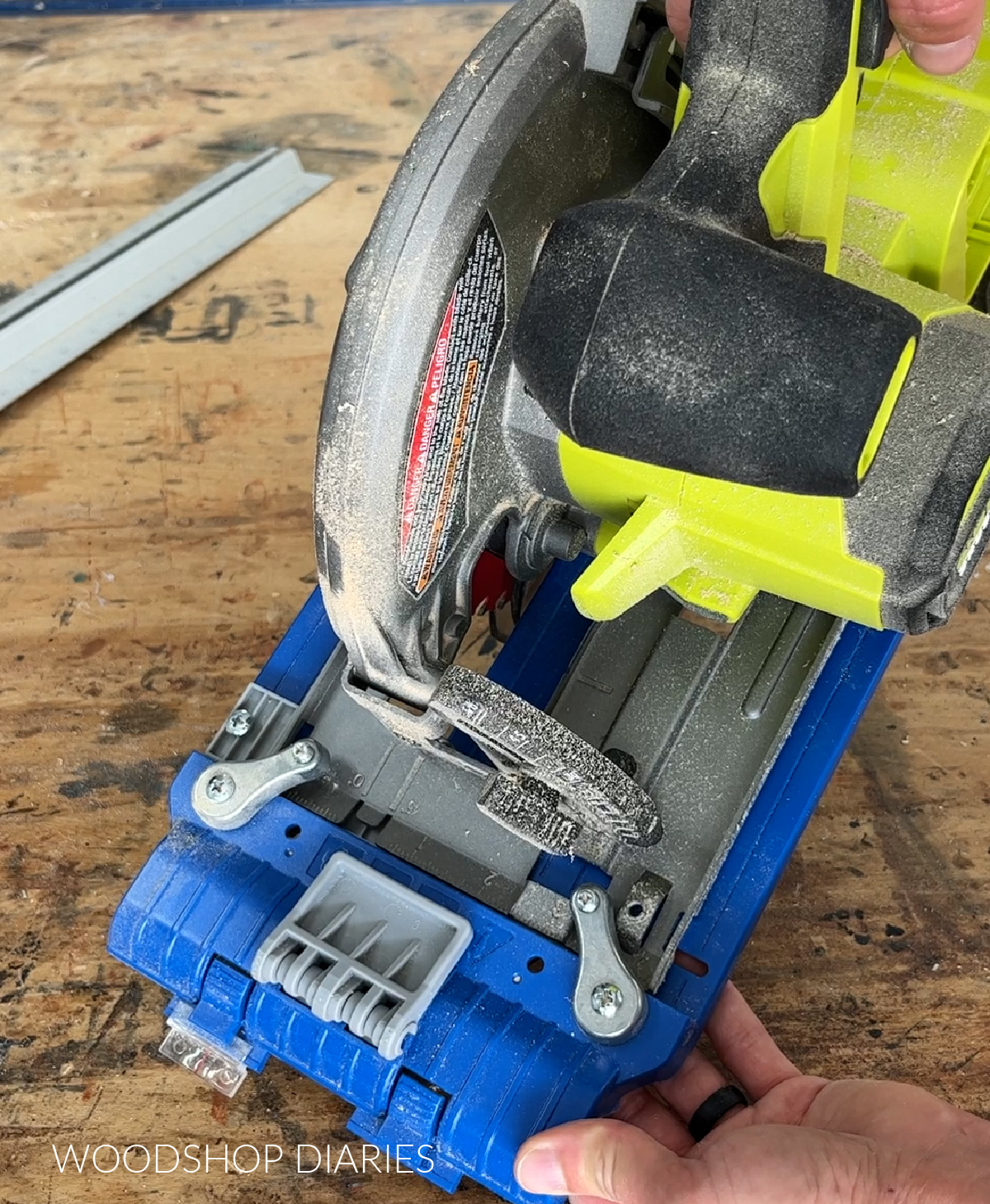 Close up of blue sled from Rip Cut guide attaching onto saw plate