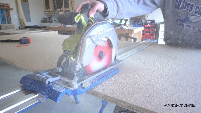 Using a circular saw to cut down plywood sheet