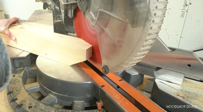 Miter saw set to 60 degrees cutting taper on end of desk leg