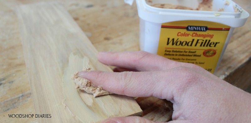 Applying first coat of wood putty to fill pocket hole