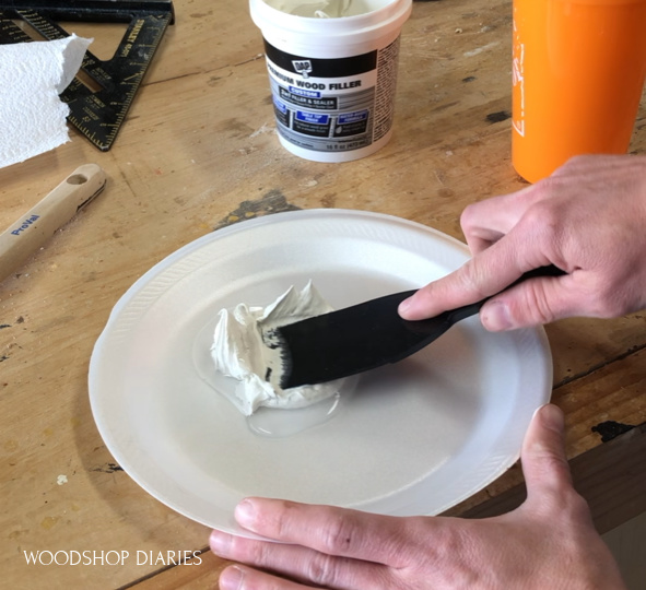 mixing grain filler with water to create a putty