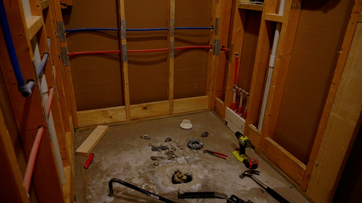 Walk in shower demo complete down to studs and bare concrete