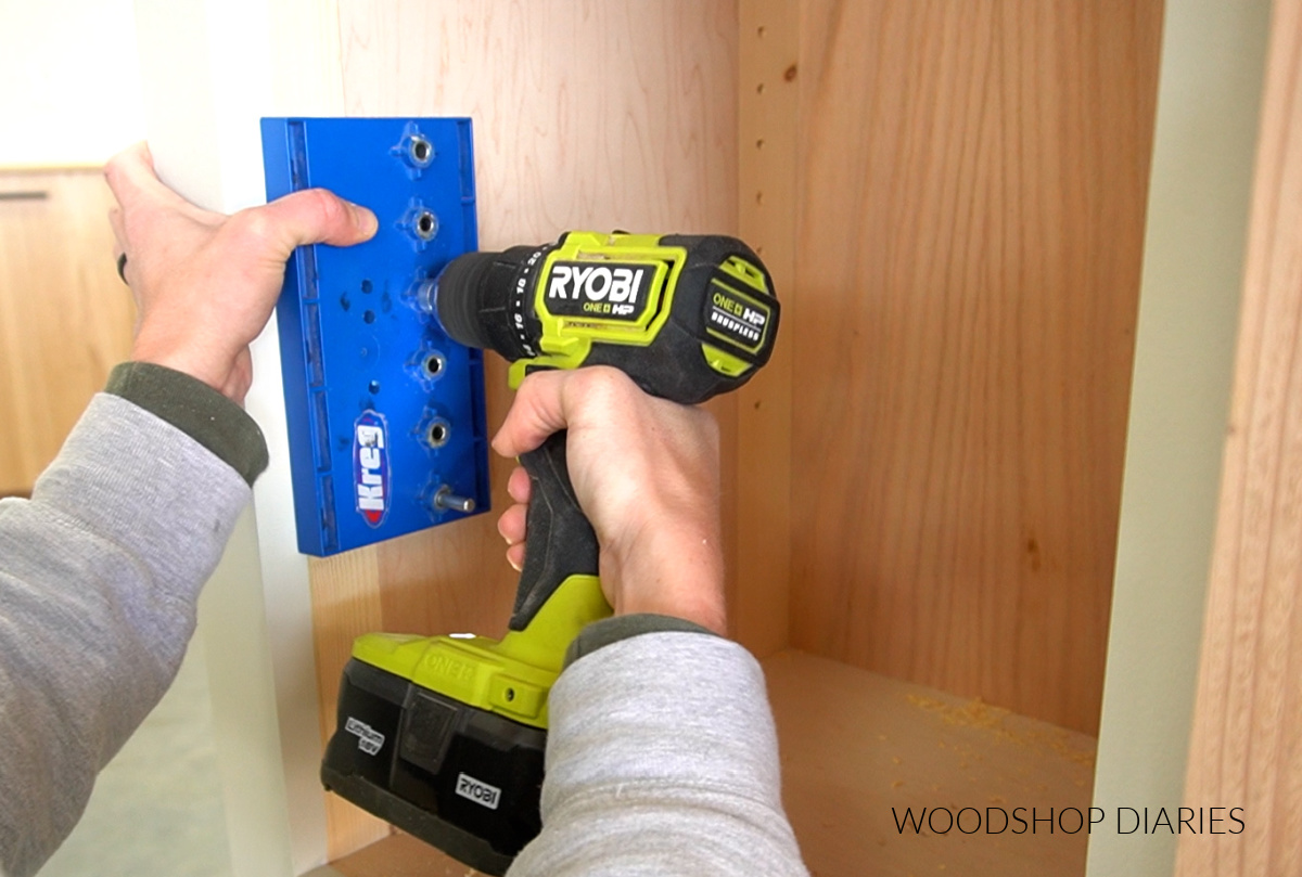 Close up of drilling shelf pin holes with a shelf pin jig