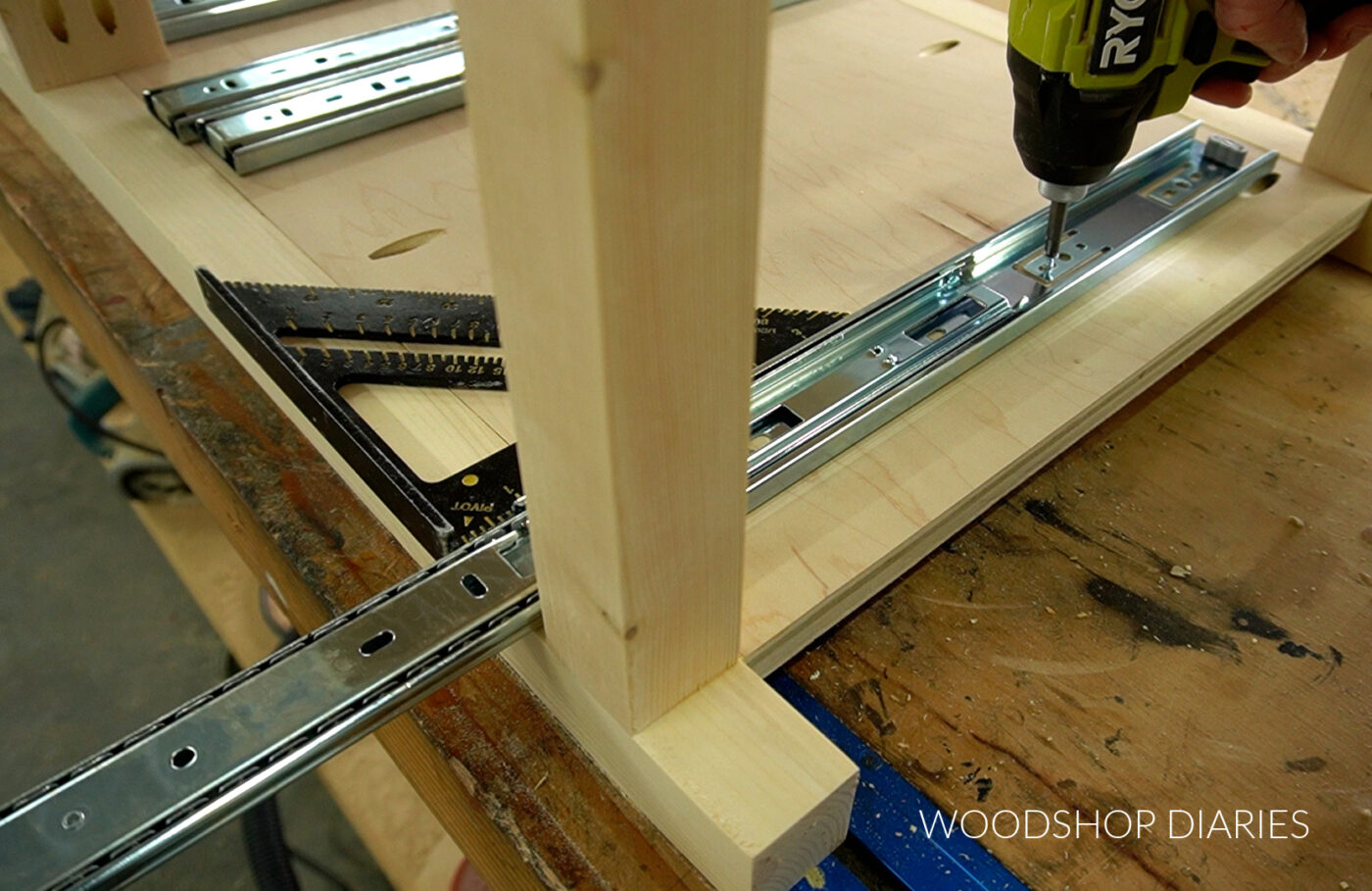 Close up installing drawer slides into cabinet
