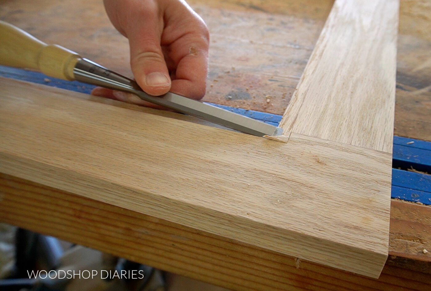 Close up of chiseling out rabbet corner on door frame