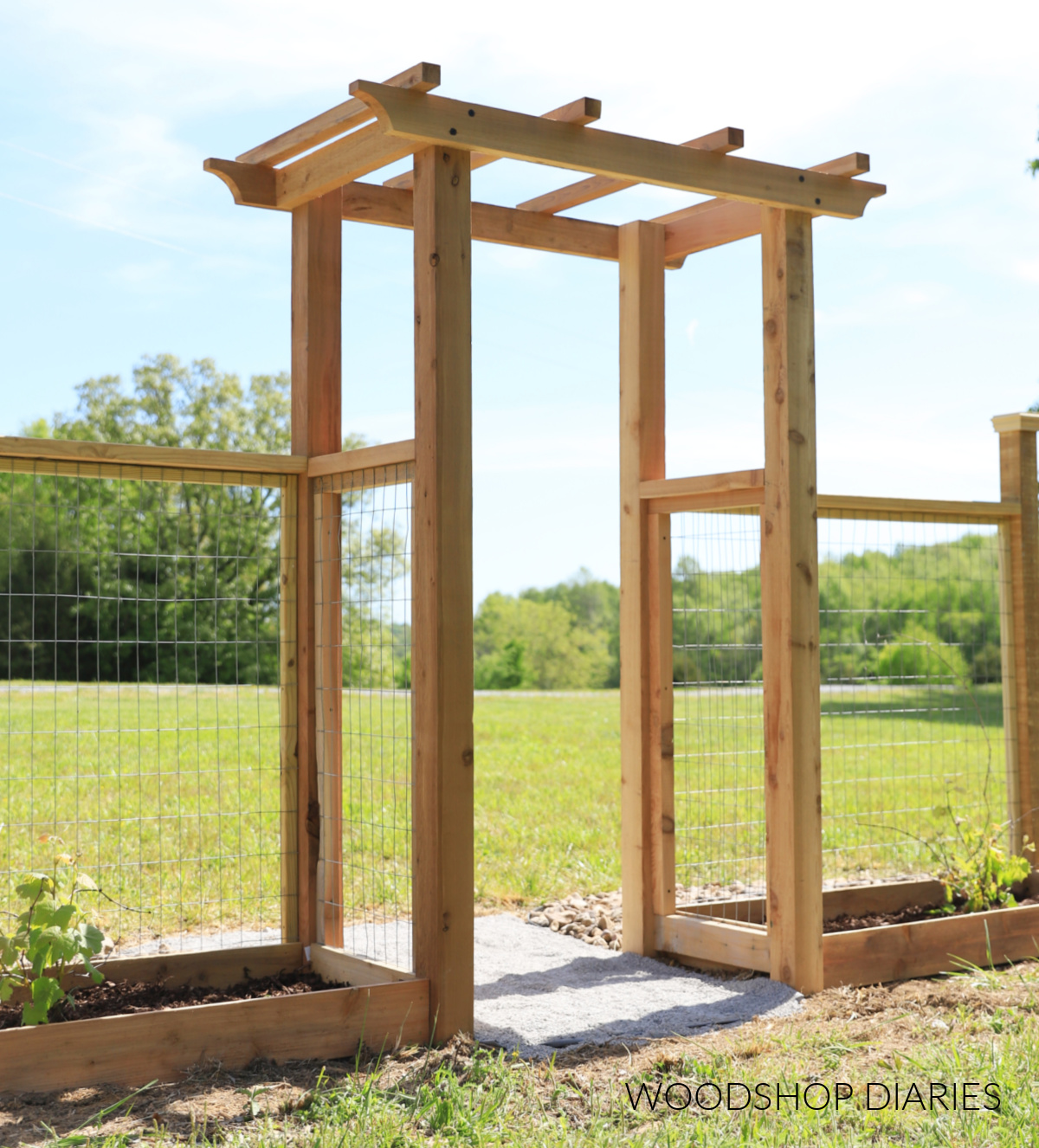 Cedar garden arbor with woven wire fence on sides