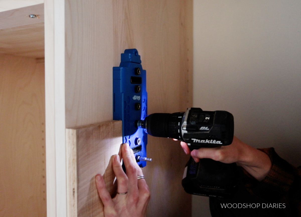 Close up of drilling shelf pin holes into cabinet
