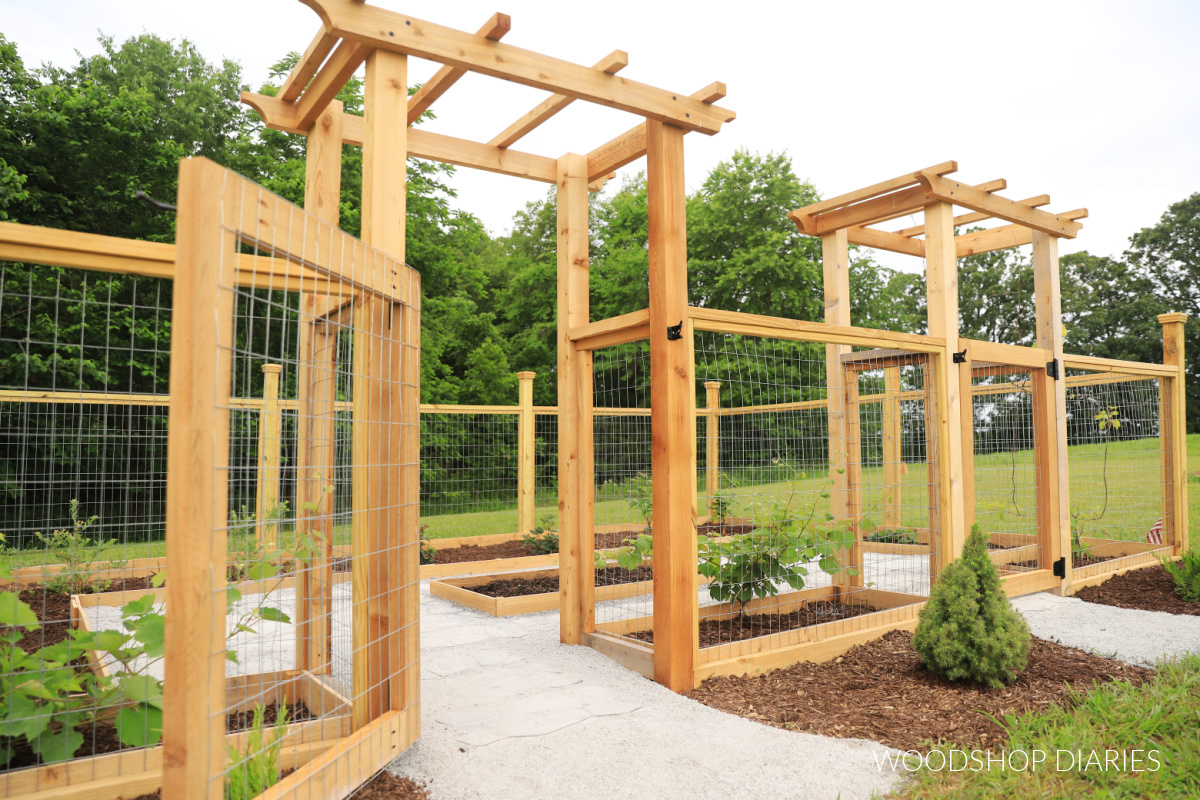 Enclosed walk in garden with two arbors and fencing all around