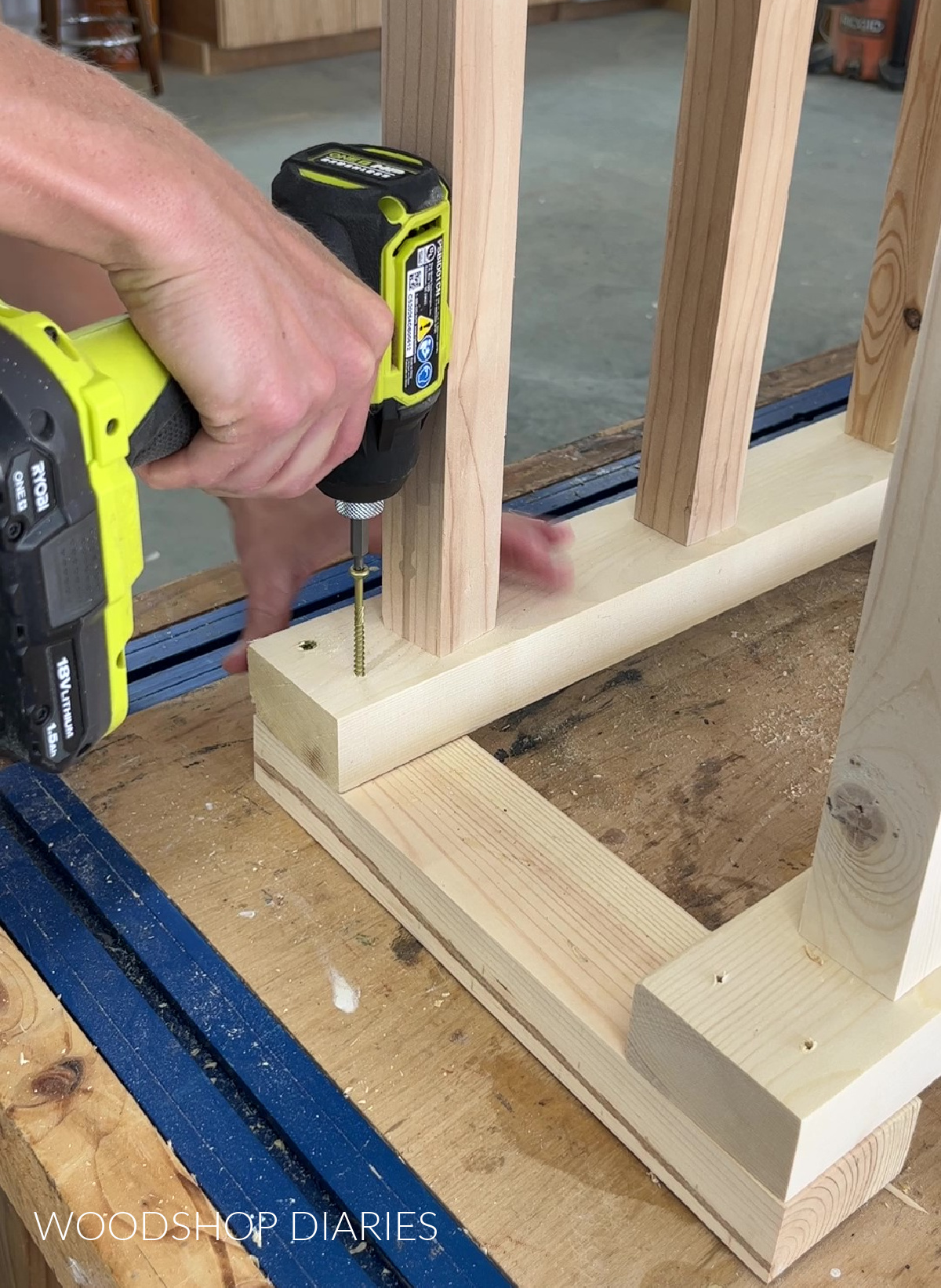 Driving screws with driver to assemble base of boot rack