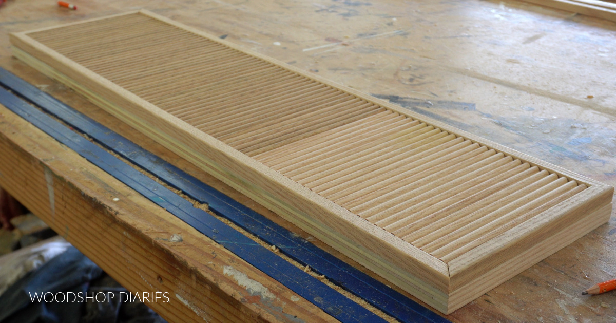 Drawer front laid on workbench with fluted trim detail on front