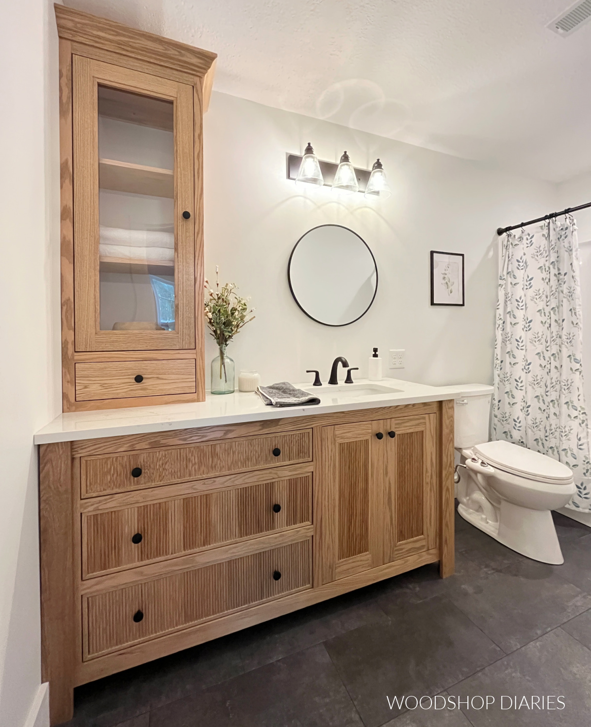 Completed DIY modern bathroom makeover with white walls, grey floor, and wood vanity