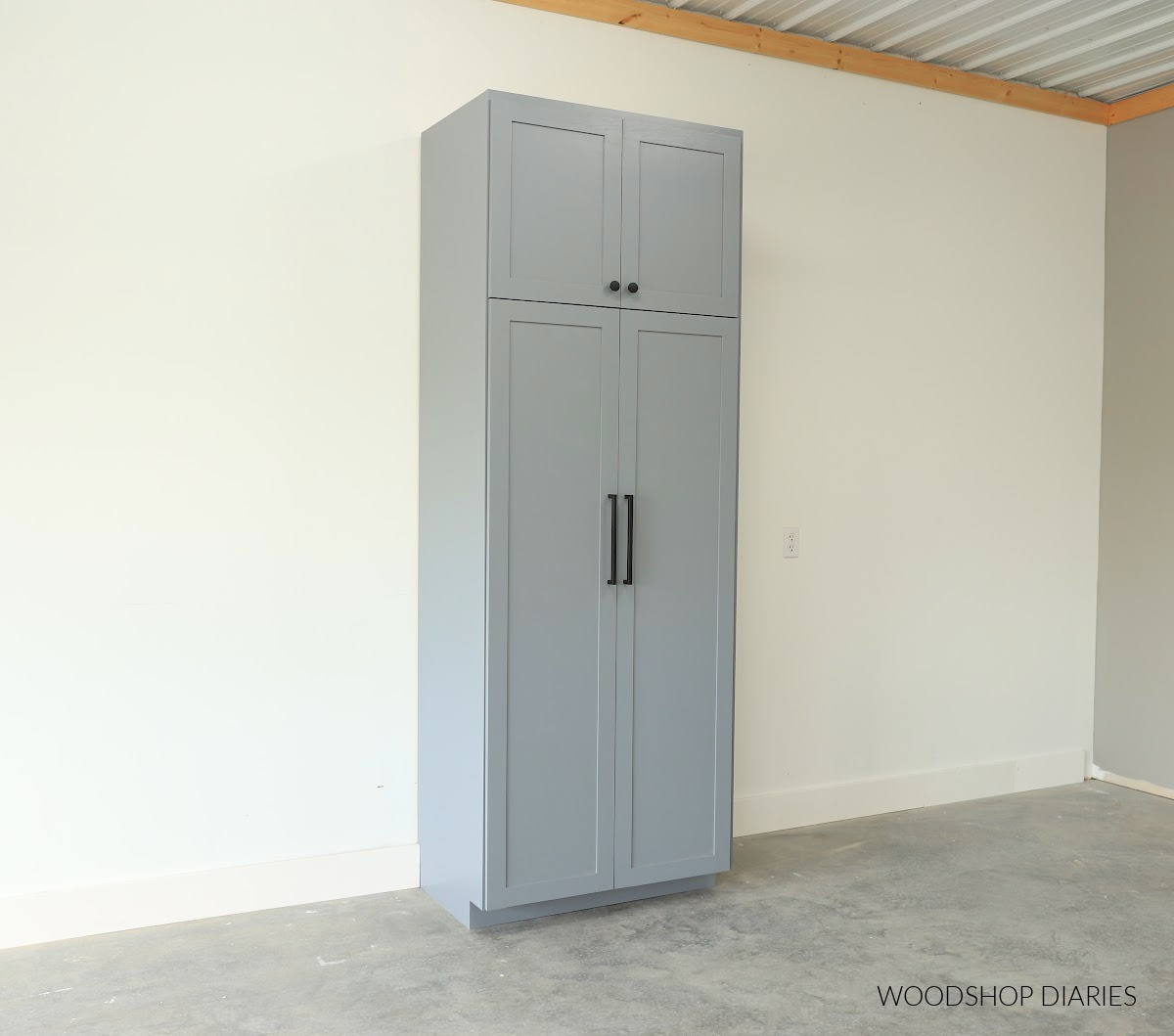 Completed tall pantry cabinet with four doors painted grey