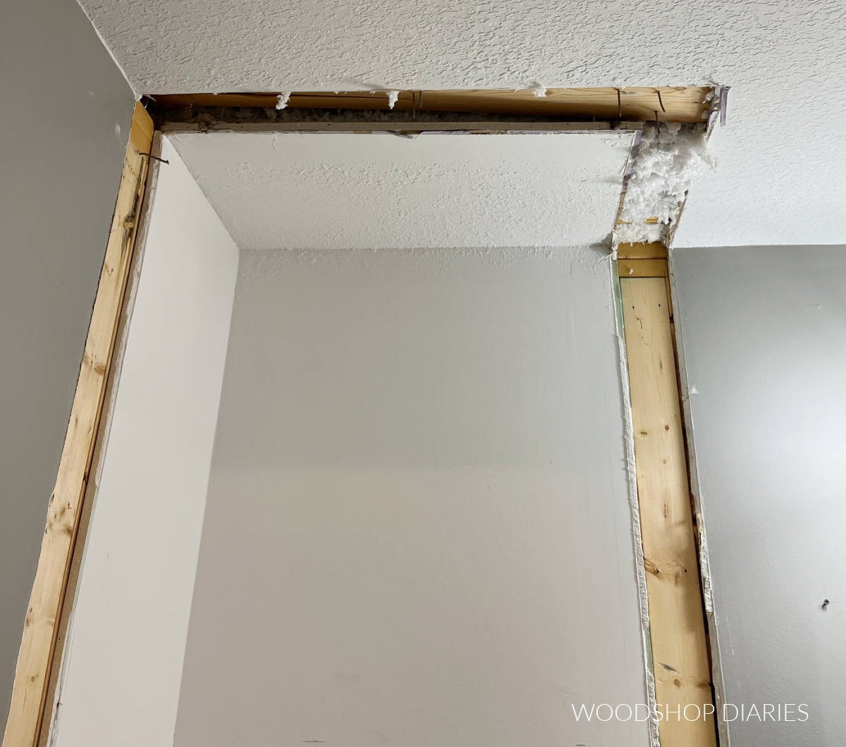 Closet removed from bathroom revealing gaps that need to be patched in drywall
