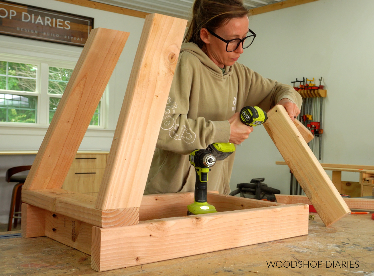 Shara Woodshop Diaries securing corner posts of range hood cover on workbench