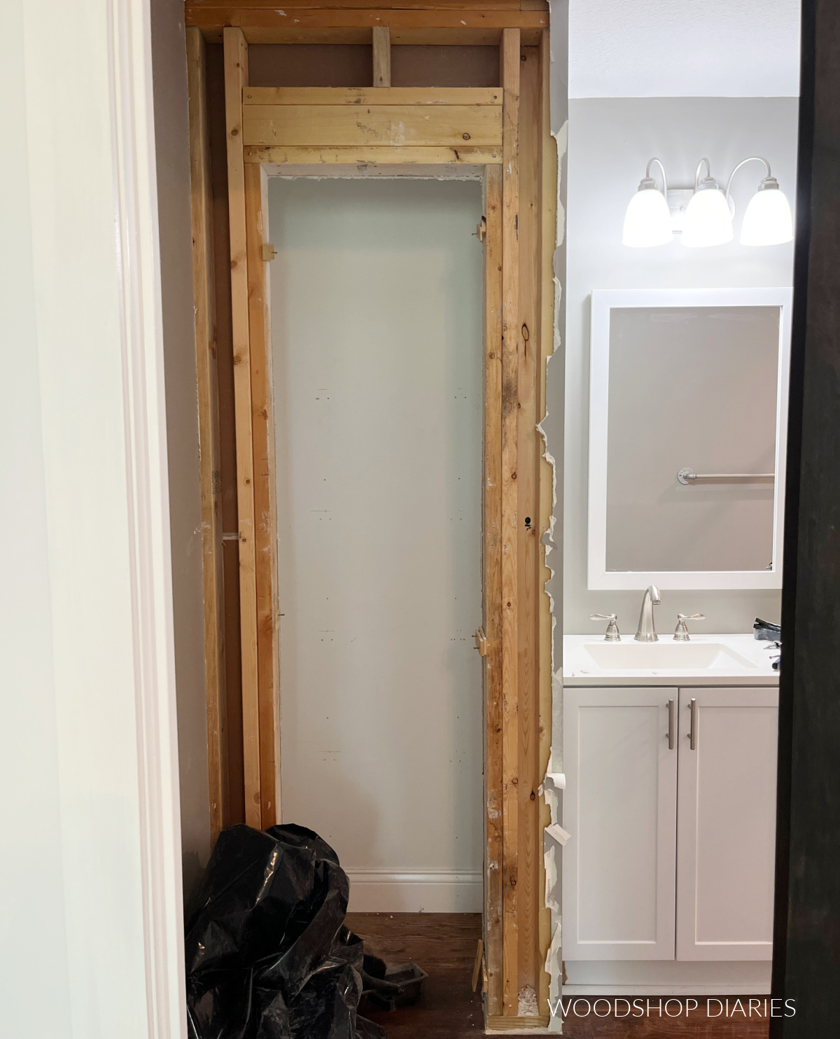 Small bathroom closet with door and trim removed