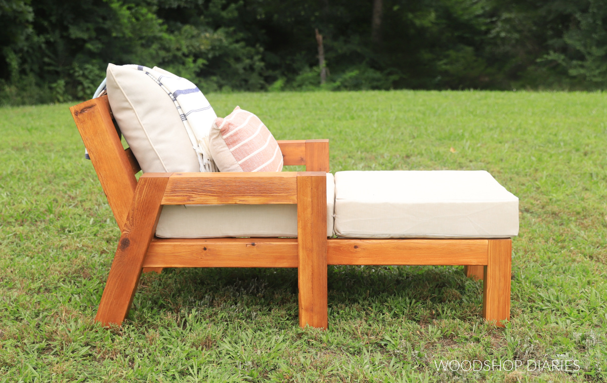 Completed DIY outdoor chaise lounge chair in grass with tan cushions--side view