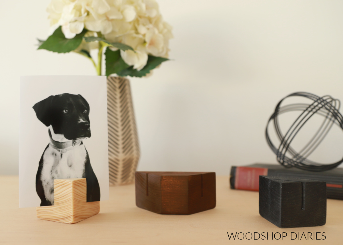 three wood blocks with picture/card holder slots cut stained various colors on wood top