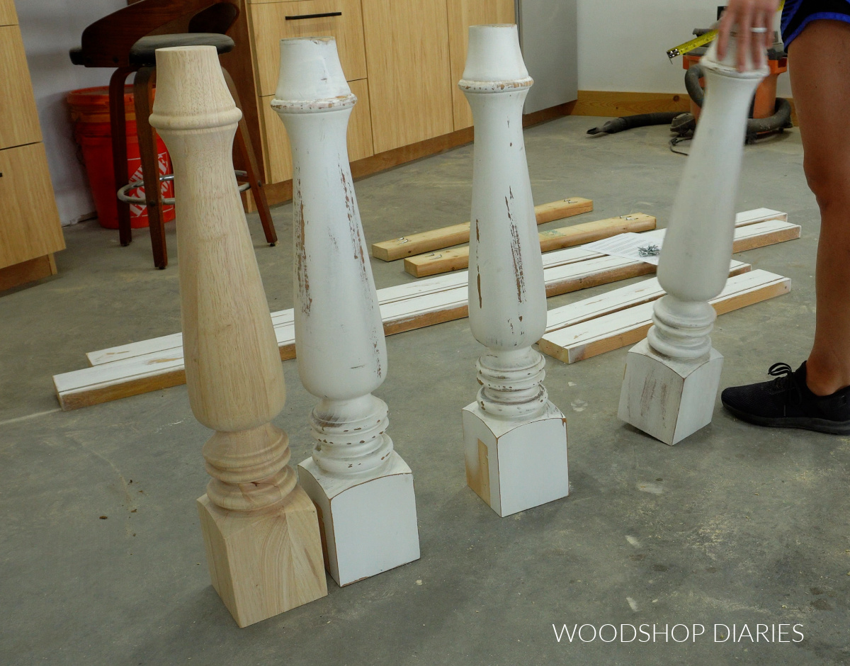 Four chunky dining table legs standing on workshop floor