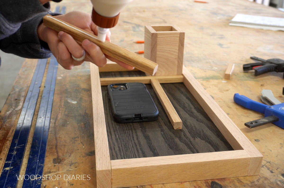 Shara Woodshop Diaries gluing dividers into wooden catch all tray organizer on workbench