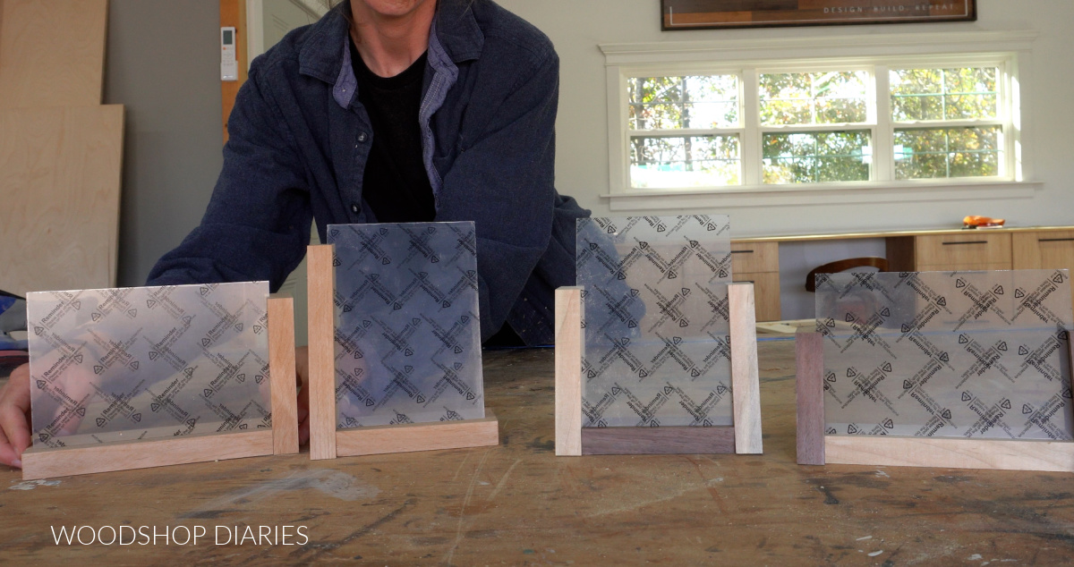 Four DIY desktop photo frames dry fit together with acrylic sheets on workbench before glue up