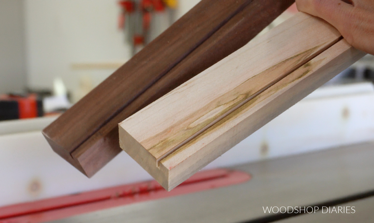Slots cut in walnut and maple 1x2s to fit photo and acrylic sheet