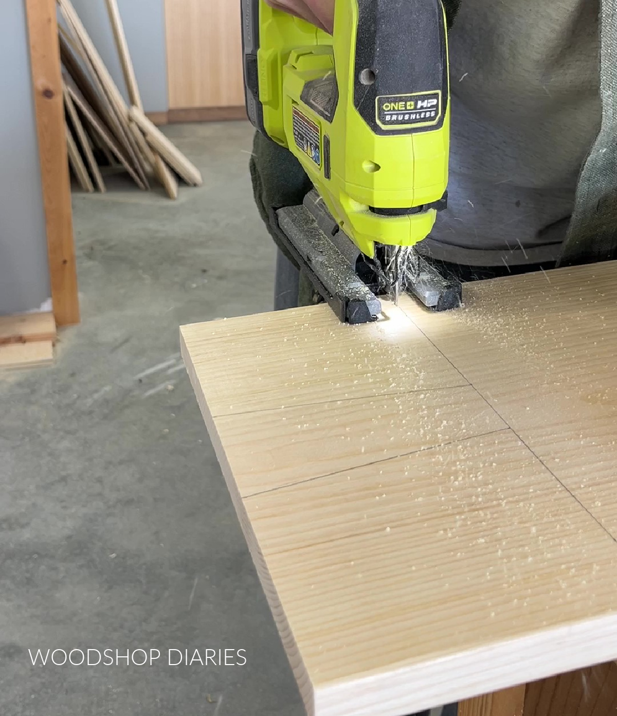 Close up of jig saw cutting handle shape out of wood board
