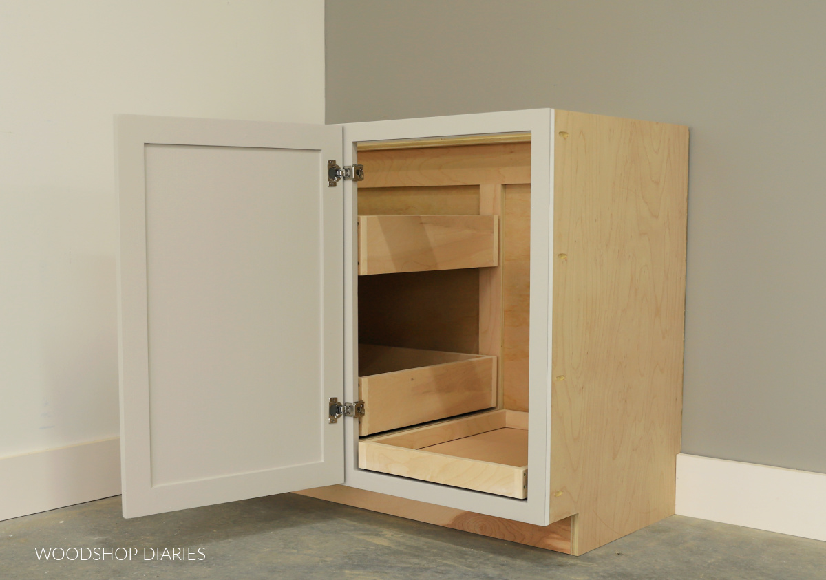 Completed DIY blind corner cabinet with door open to reveal custom built drawers 