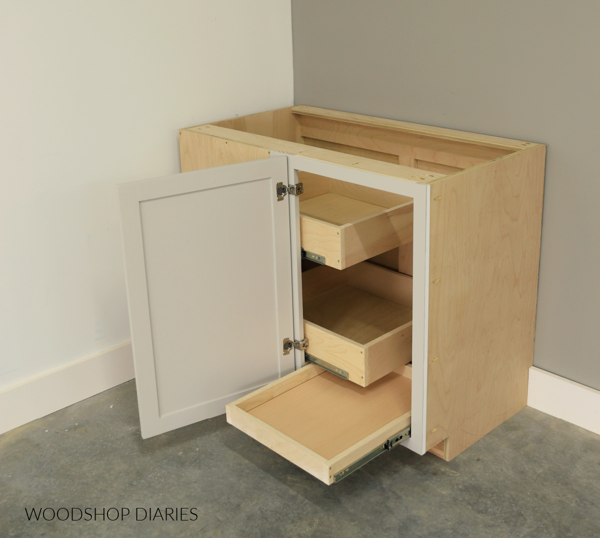 DIY blind corner cabinet with door open showing custom drawers installed to utilize storage space in the back