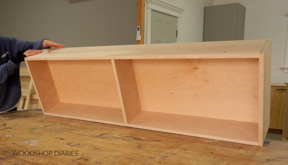 Large plywood drawer box assembled on workbench with divider in the middle