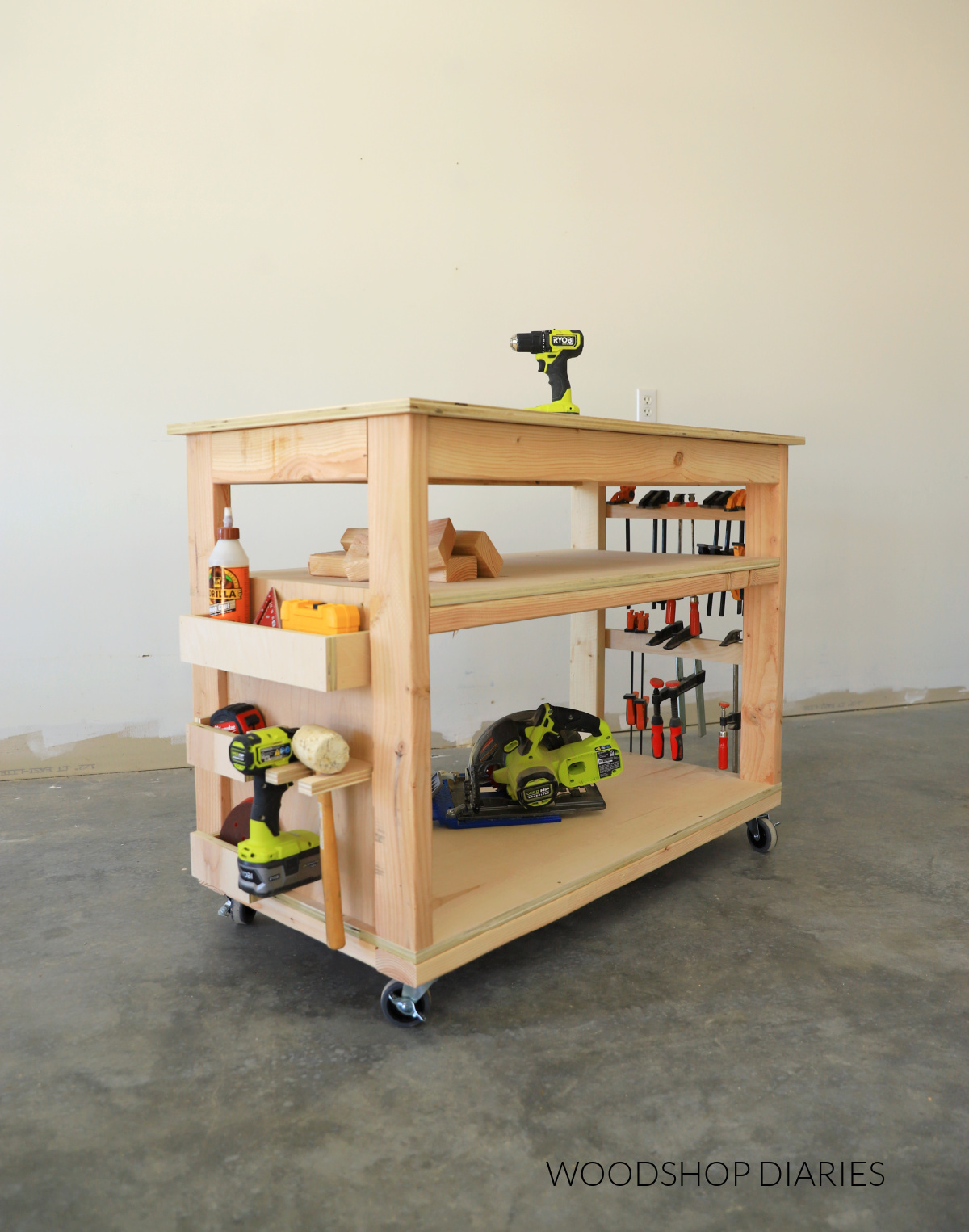 Small DIY mobile workbench with shelf--storage cubbies on one side and clamp racks on the other