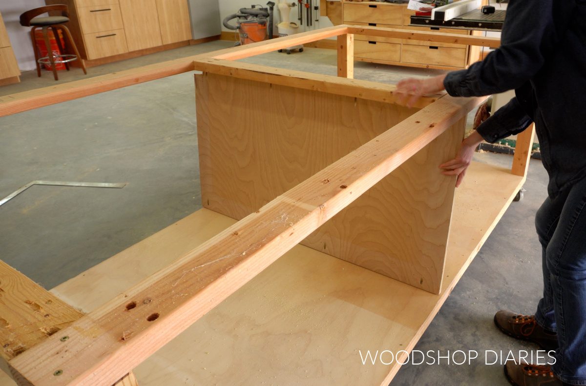 Shara Woodshop Diaries installing middle divider panel into workbench frame