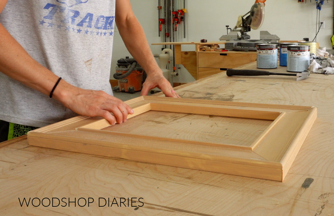 Dry fitting four sides of DIY picture frame together on workbench