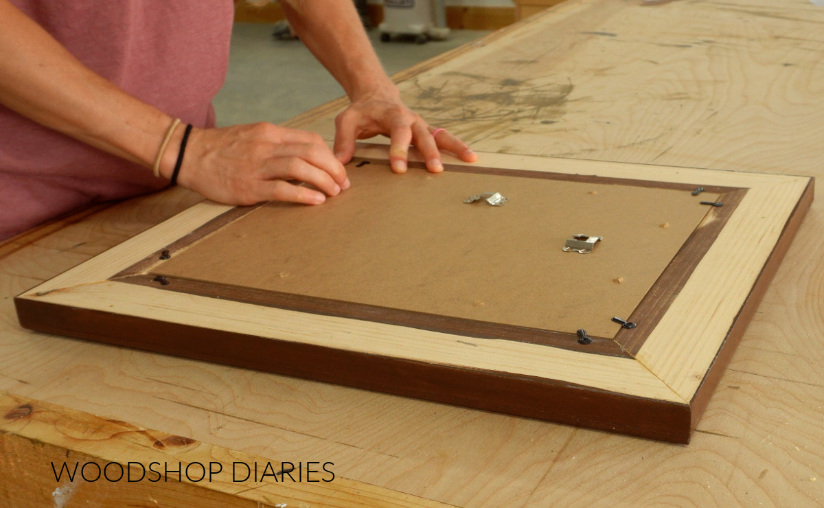 Installing plexiglass, mat, picture, and backer board into wooden picture frame with turn buttons