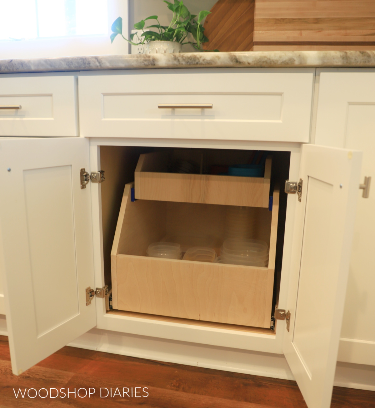 DIY cabinet organizer drawer installed into base kitchen cabinet with doors open
