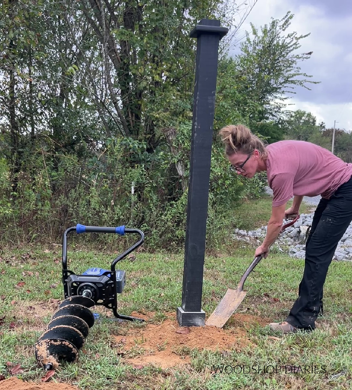 Shara Woodshop Diaries backfilling around post hole with dirt