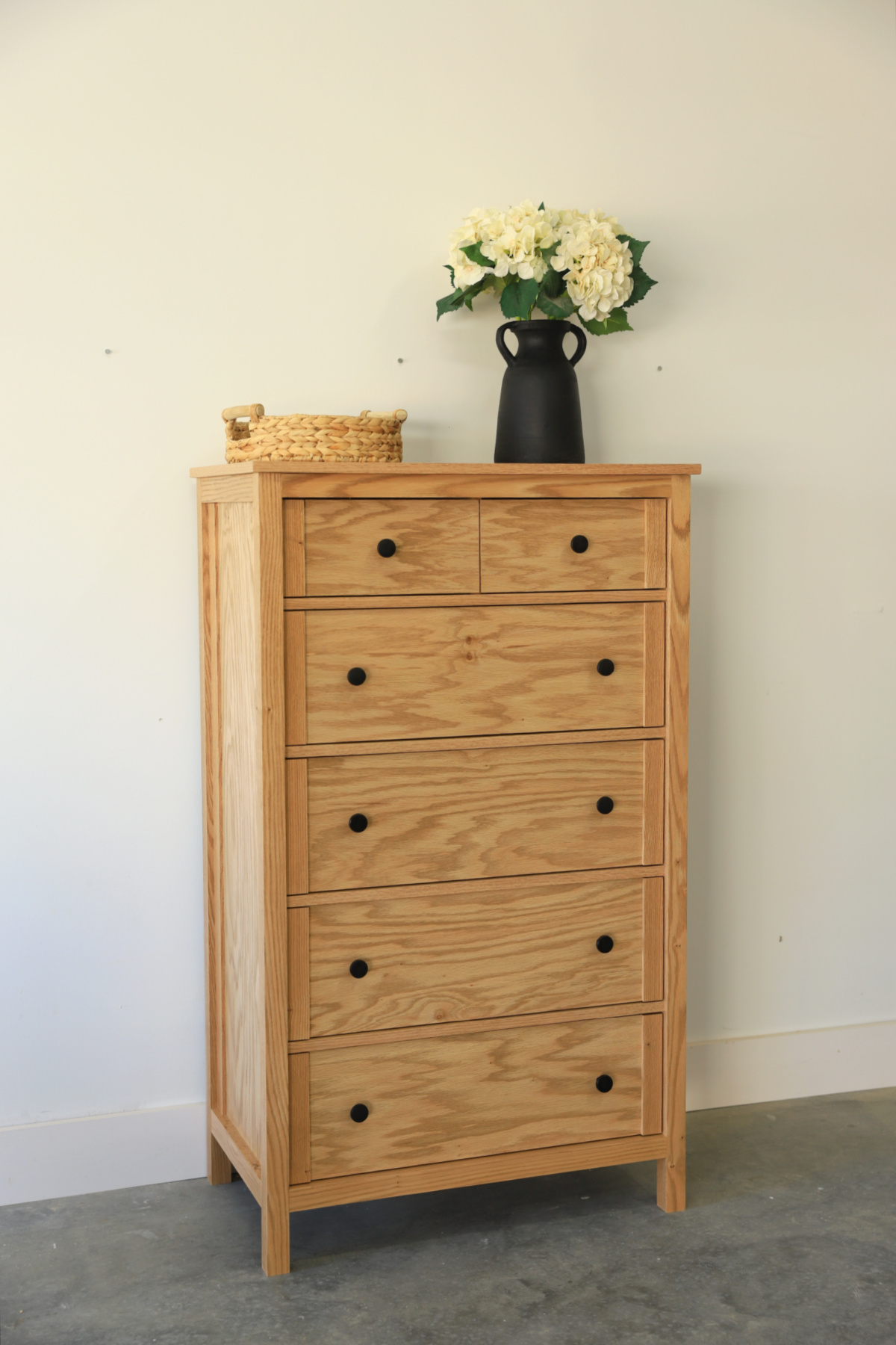 Tall DIY 6 drawer red oak chest of drawers dresser against white wall